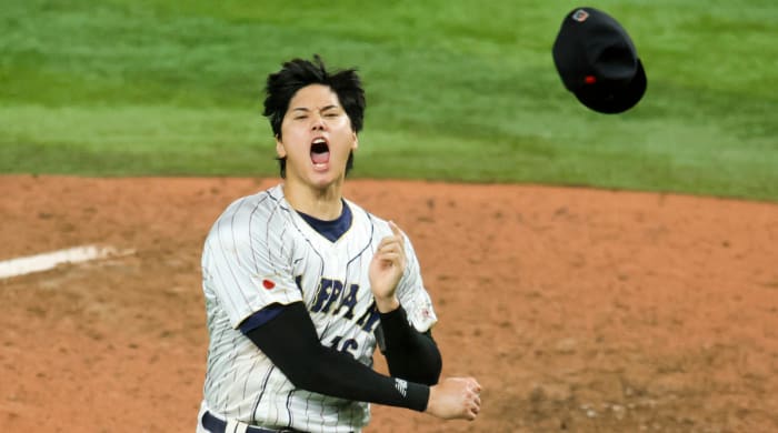 Shohei Ohtani throws his hat in celebration after striking out Mike Trout to win the World Baseball Classic for Japan